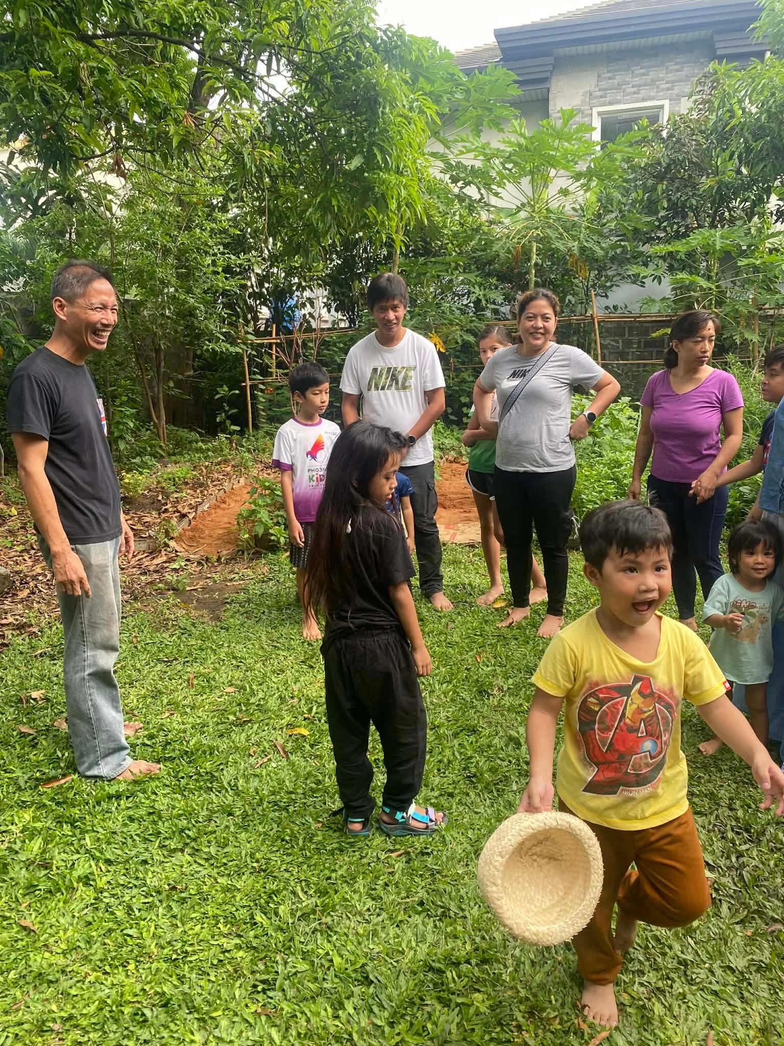 Families gathering in a welcome circle on the lawn