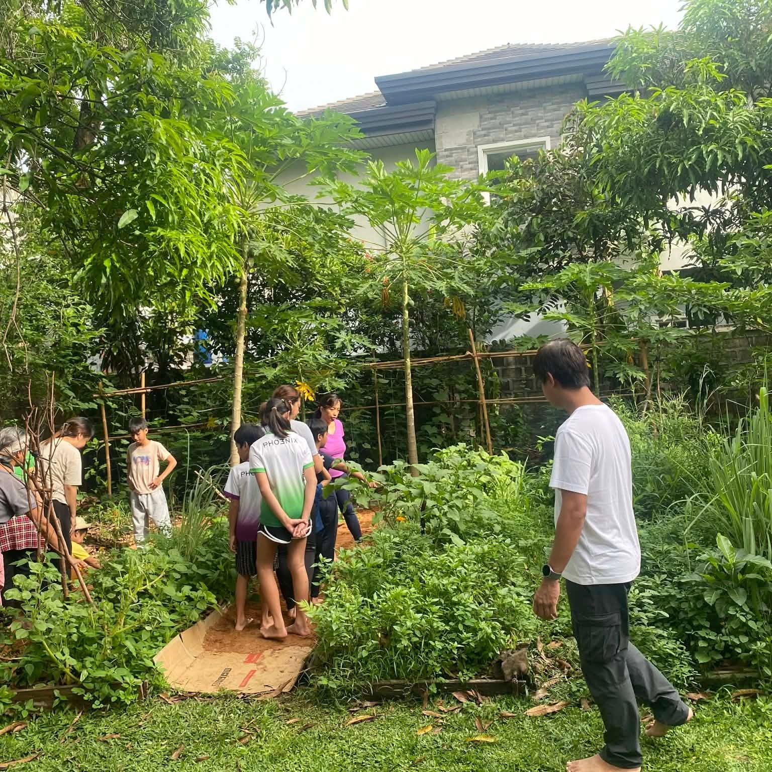 Parent-child teams walking through the garden beds