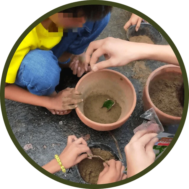 Children at Right Start potting seedlings in clay pots